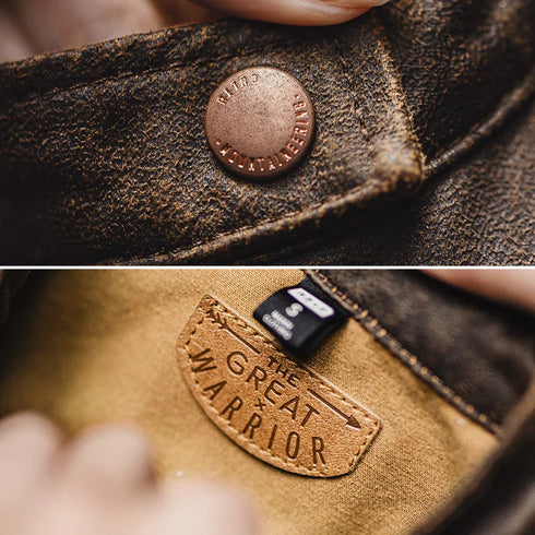 Close-up of a leather product with a brand label and a tag on fabric.